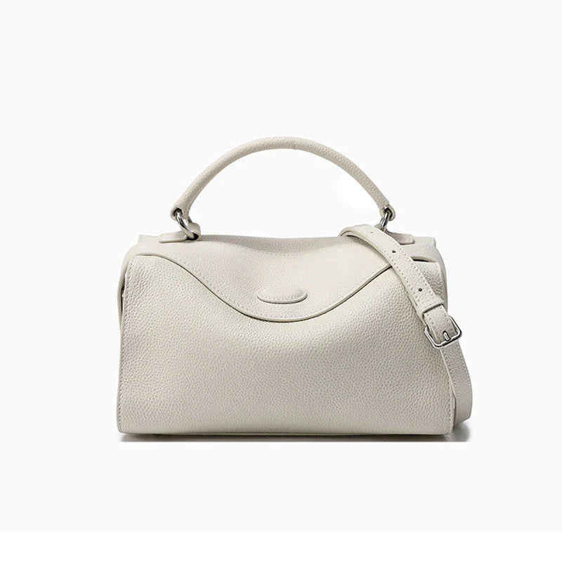 Premium cowhide leather crossbody bag with a unique pillow-shaped design, multiple interior pockets, and an adjustable strap for comfortable everyday wear.