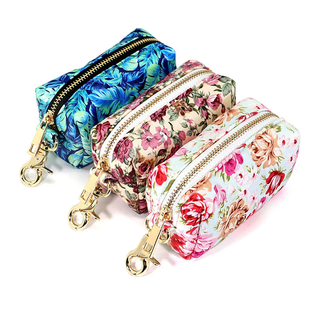 Durable nylon dog bag with floral print design, featuring multiple compartments for treats, waste bags, and other essentials.