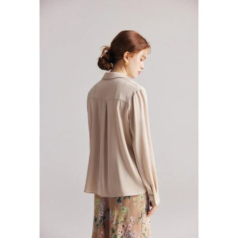 Elegant ruffled silk blouse in champagne color with V-neck design, suitable for professional or casual wear