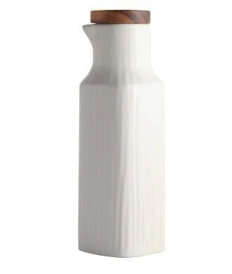 A matte white ceramic oil dispenser with a sleek and minimalist Nordic-inspired design, perfect for any Kiwi kitchen.