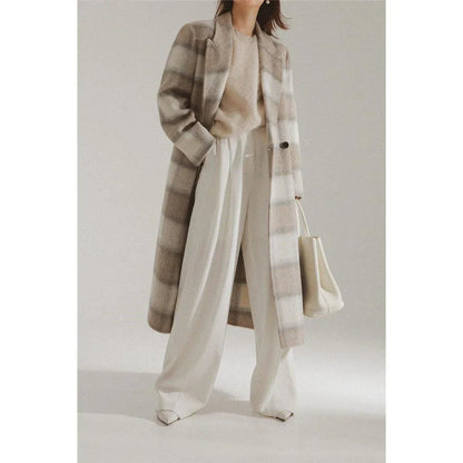 A stylish plaid double-breasted long wool coat for fashionable Kiwi women, featuring a cozy and elegant design with functional pockets and a versatile turn-down collar.