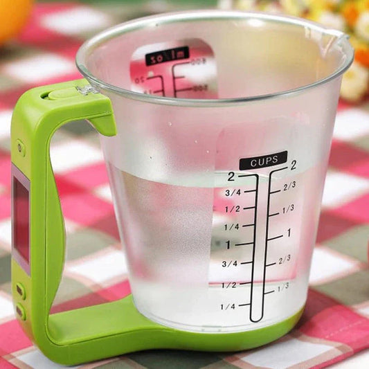 A green digital measuring cup with an LCD display integrated into the handle, designed in New Zealand for precise kitchen measurements