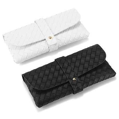 Stylish black and white twist braided leather sunglasses case with snap closure, protecting eyewear in a fashionable way