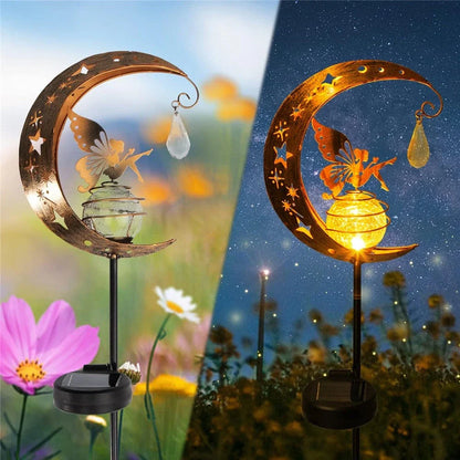 Decorative solar-powered fairy garden light with a glass globe and moon and fairy design for outdoor illumination