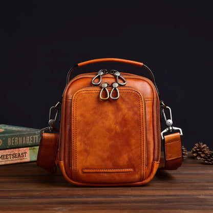 A rugged, retro-inspired cowhide messenger bag made in New Zealand, featuring a spacious interior, multiple pockets, and a comfortable single strap design.