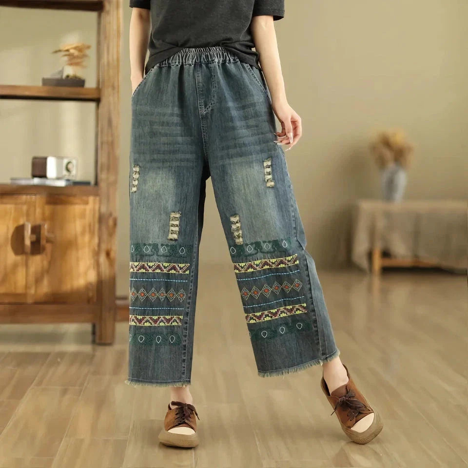 Vintage-inspired embroidered wide-leg jeans in a relaxed, bohemian style with a high-waist design and elastic closure for a personalized fit