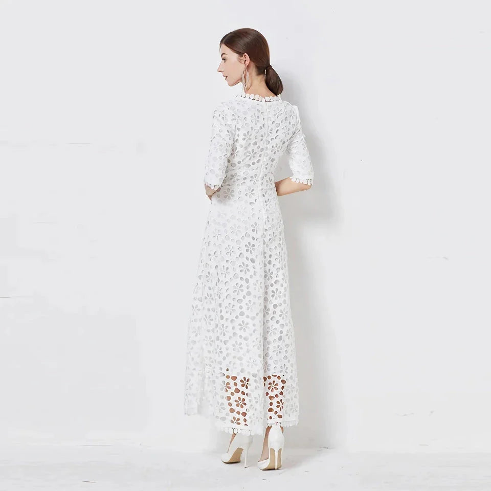 A white lace maxi dress with a stylish V-neck design, perfect for special occasions.