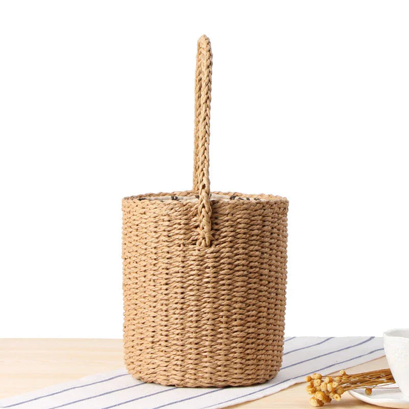 Hand-crafted straw bucket bag in camel and beige colors, featuring a compact and lightweight design for everyday Kiwi summer use