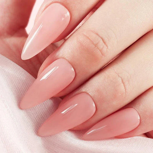 Handcrafted nude pink press-on nails with a long, almond shape for a sophisticated, minimalist look.