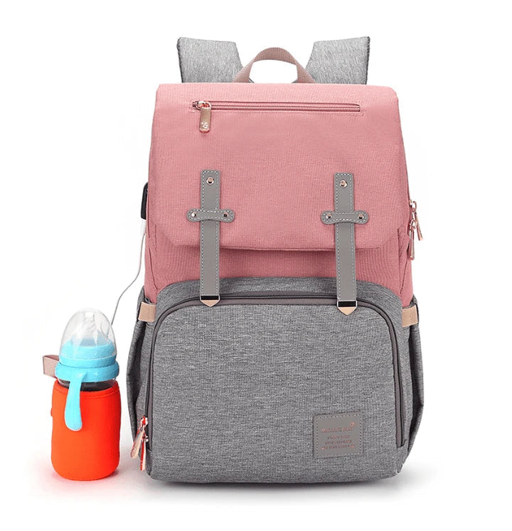Versatile mum's backpack with pink color, featuring side pockets, zippered compartments, and stroller attachment hooks