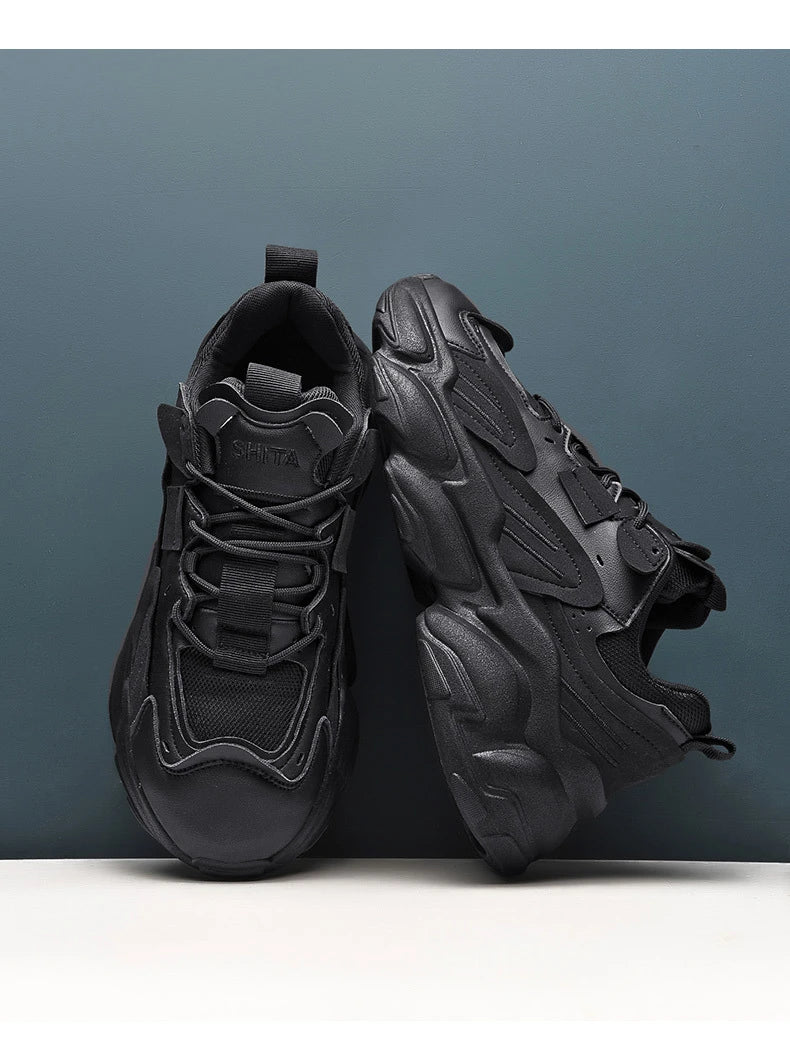 Pair of white, black, and gray casual sports sneakers with leather upper and rubber sole