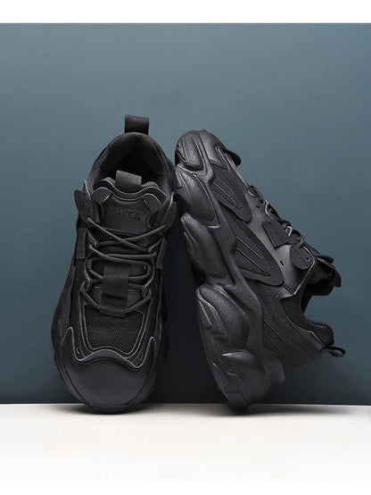 Pair of white, black, and gray casual sports sneakers with leather upper and rubber sole