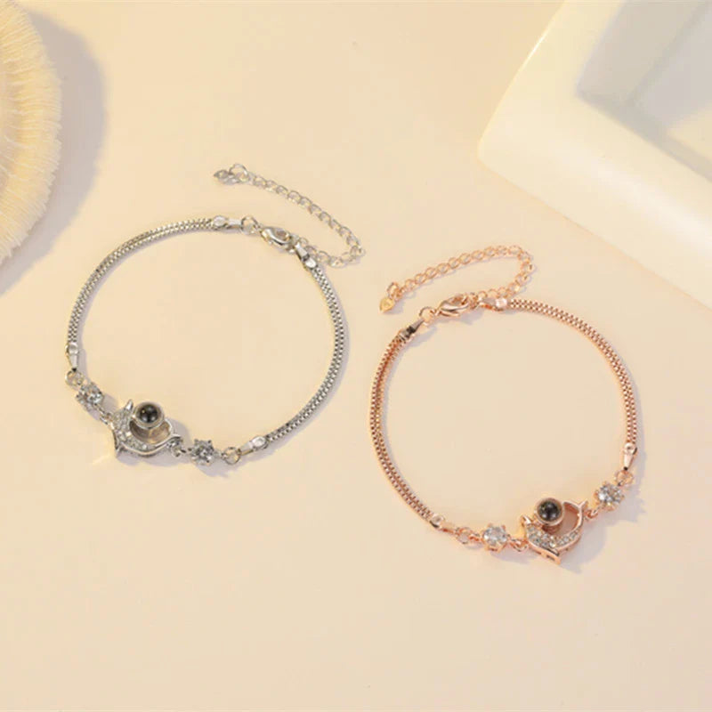 A pair of vibrant projection couple bracelets in rose gold and platinum colors