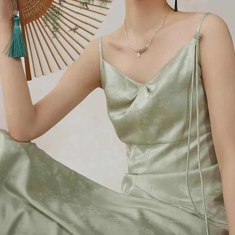 Elegant and stylish mint green midi dress with spaghetti straps, perfect for summer events and occasions.