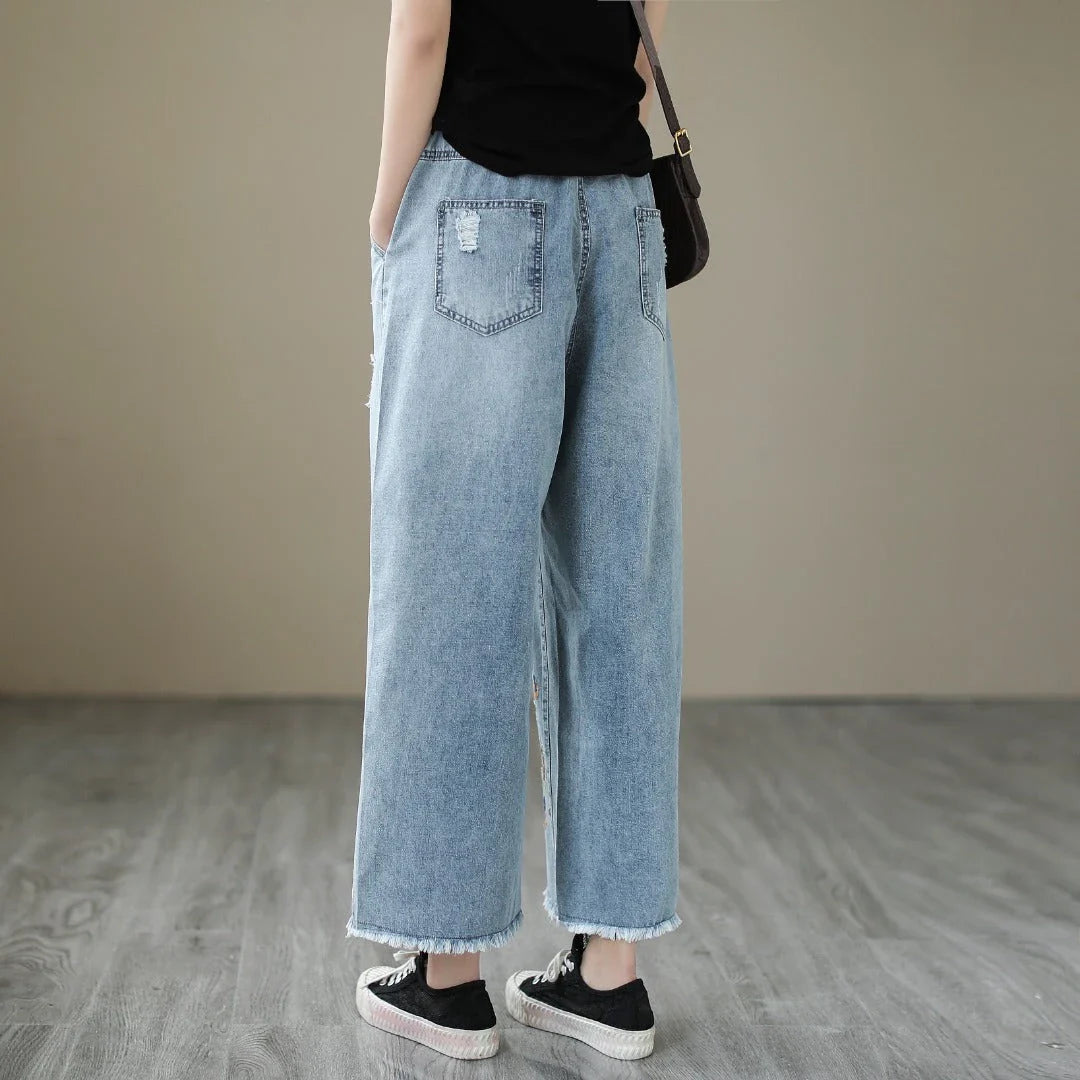 Embroidered denim jeans with distressed details, perfect for the modern Kiwi lifestyle