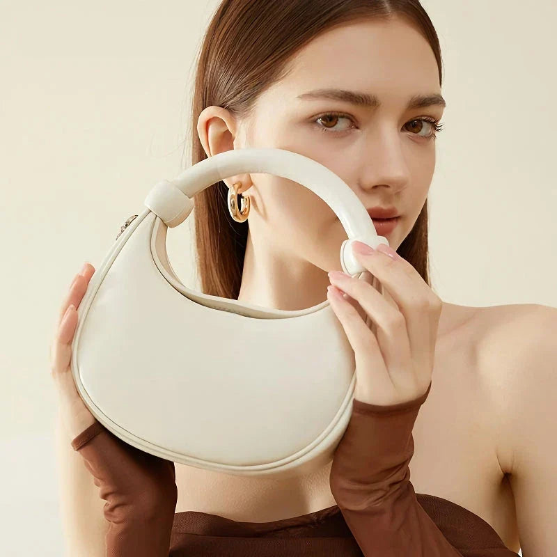 Rose Pink Leather Crescent Crossbody Bag with a unique half-moon design, showcasing premium craftsmanship and versatile functionality