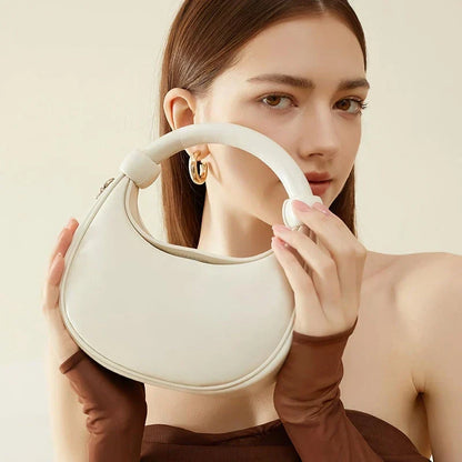 Rose Pink Leather Crescent Crossbody Bag with a unique half-moon design, showcasing premium craftsmanship and versatile functionality