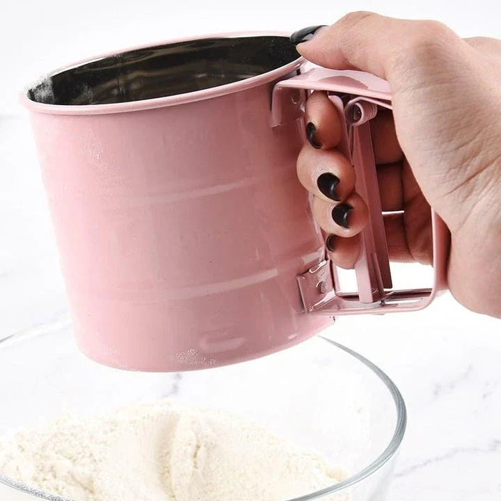 Elegant macaron pink handheld flour sifter with stainless steel construction, perfect for Kiwi bakers