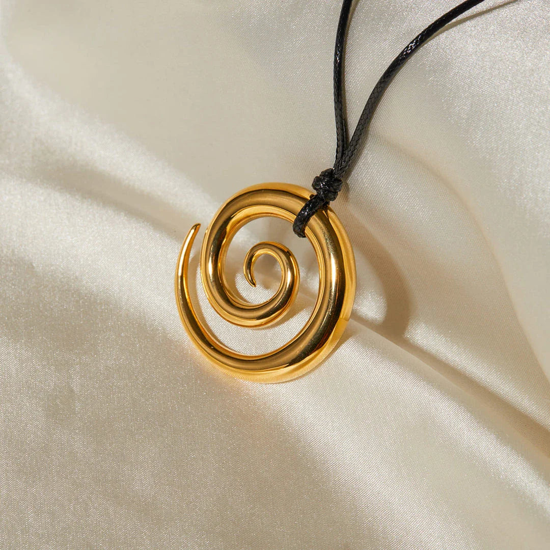 Elegant spiral circle pendant necklace in gold with black rope, a timeless accessory for Kiwi fashionistas