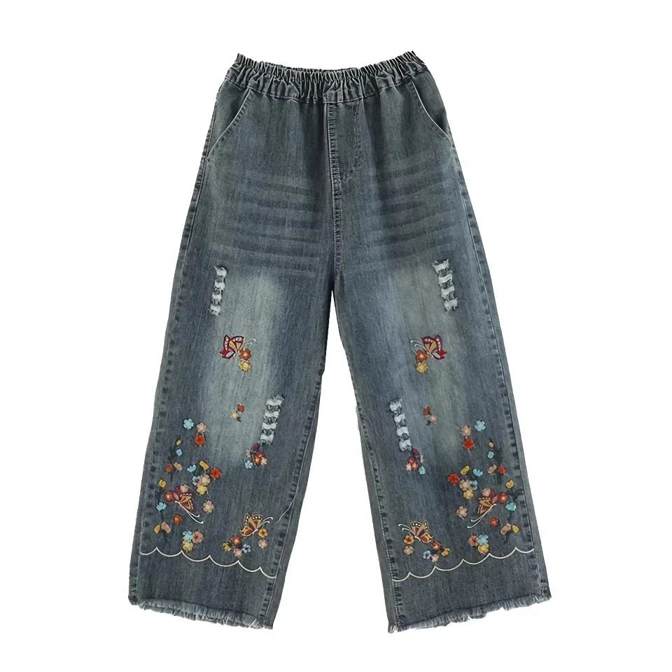 Embroidered wide-leg denim pants with a high-waist design and elastic closure, perfect for Kiwi fashion.