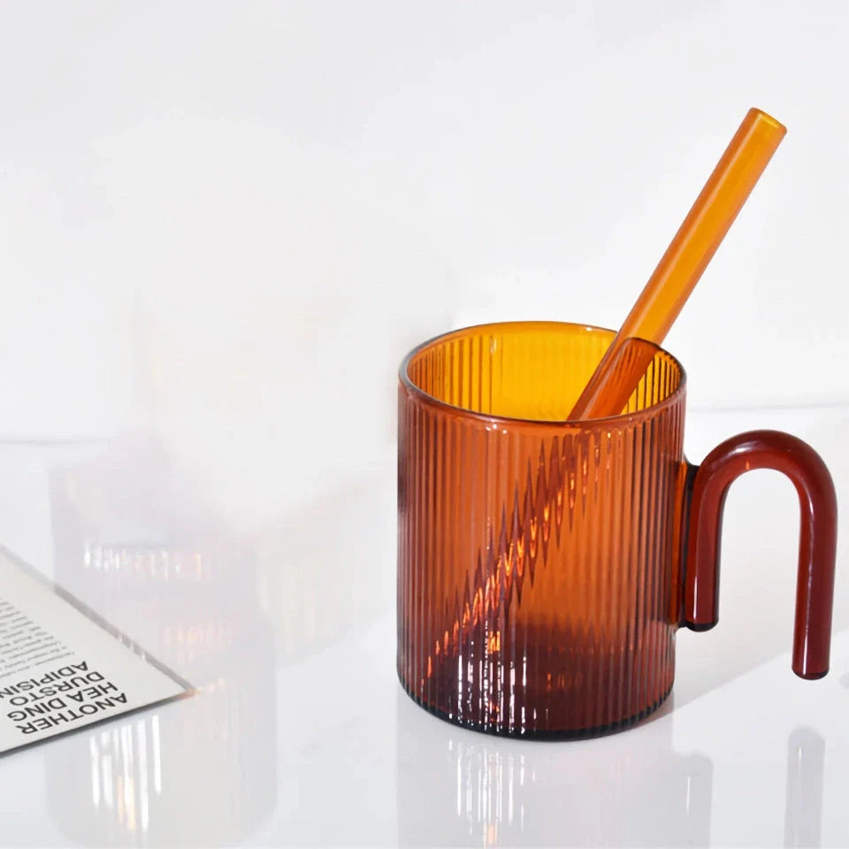 Stylish heat-resistant glass mug with vibrant colourful handle, perfect for hot beverages