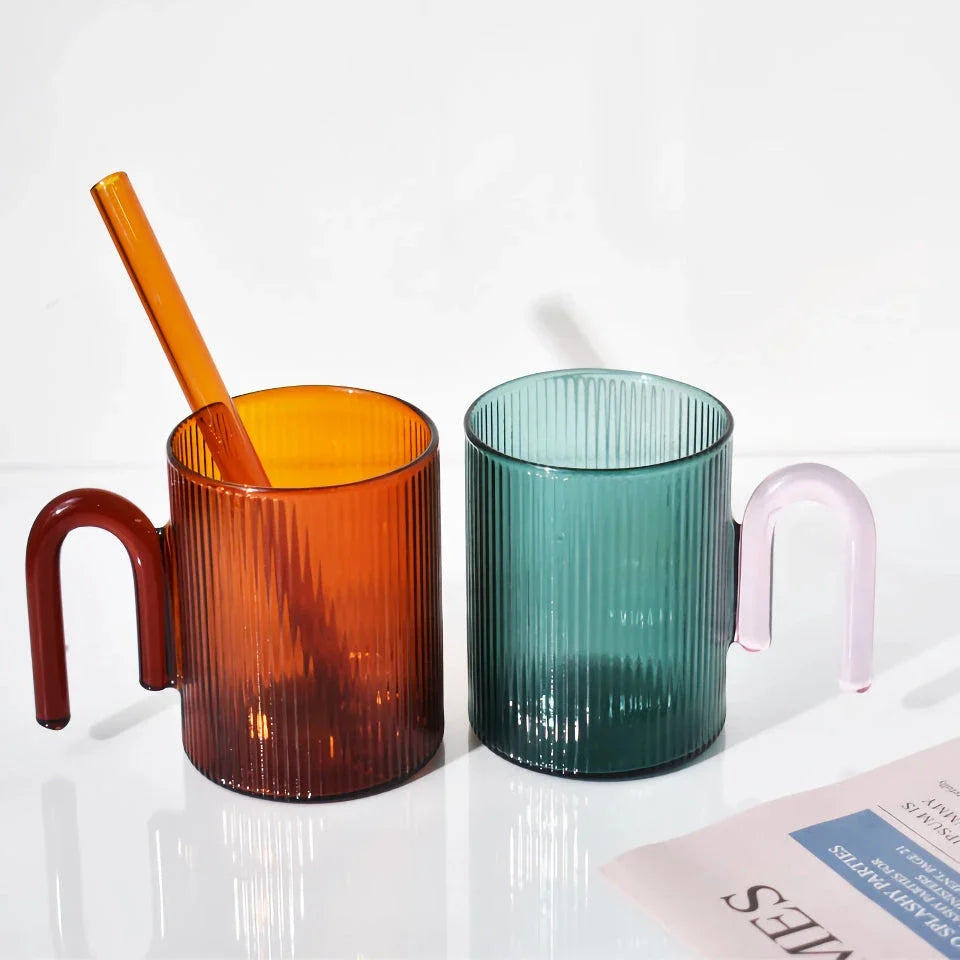 Stylish heat-resistant glass mug with vibrant colourful handle, perfect for hot beverages