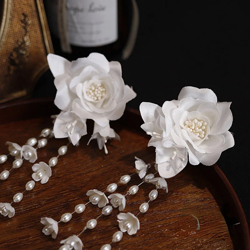 Elegant white floral ear clip with three-dimensional camellia flower and lily of the valley bud