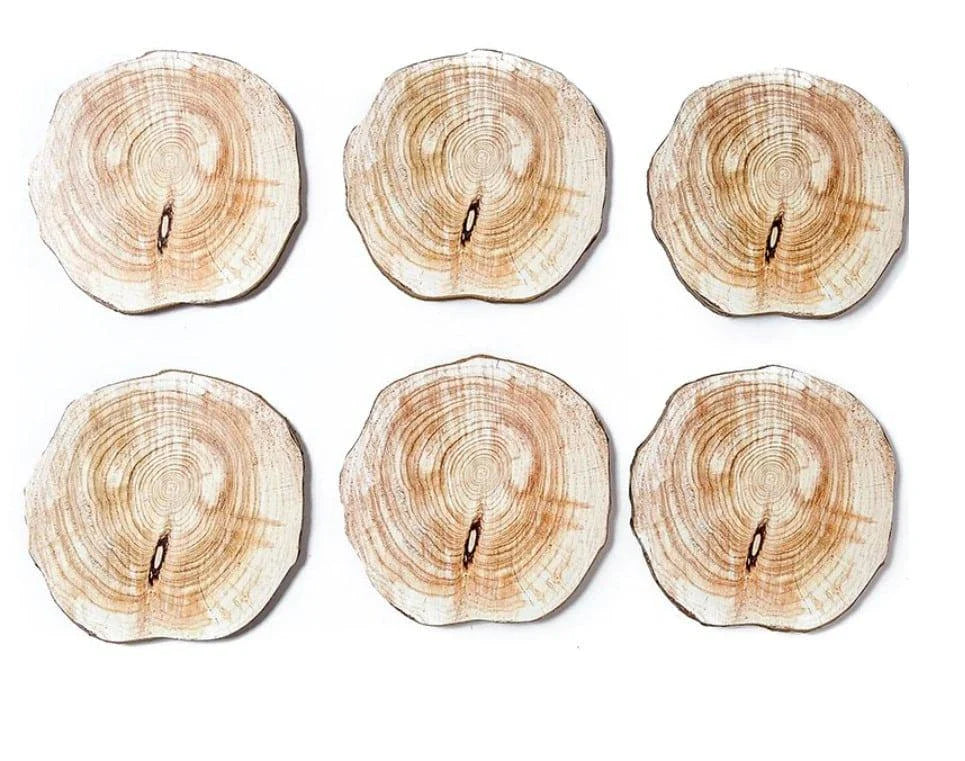 Set of 6 natural timber coasters in various grain patterns, protecting a mug on a wooden surface