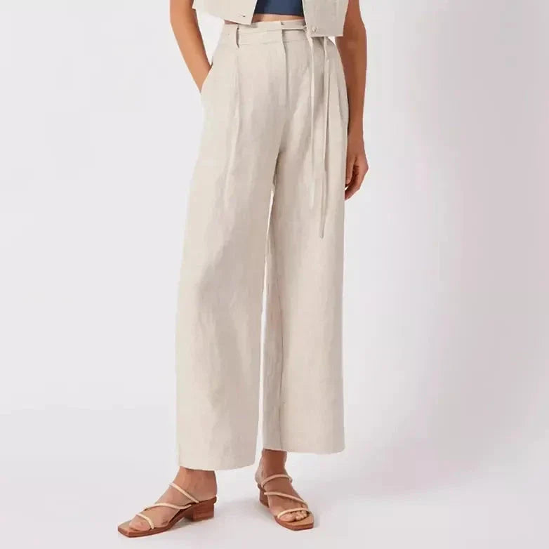 Elegant high-waist linen trousers with Korean-inspired design, featuring lace-up detail and button decorations for a sophisticated and comfortable look.