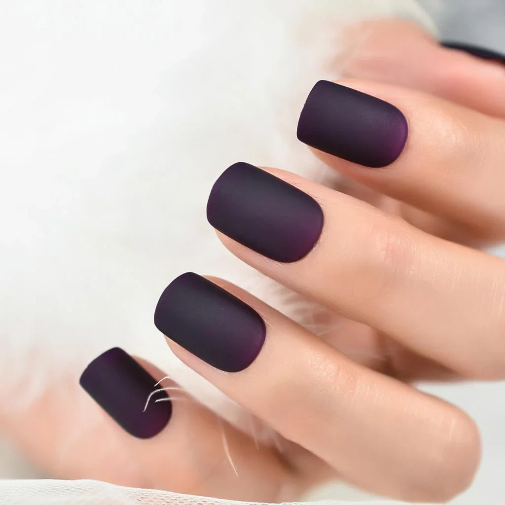 Matte purple and black squoval fake nails with a sleek, salon-quality design