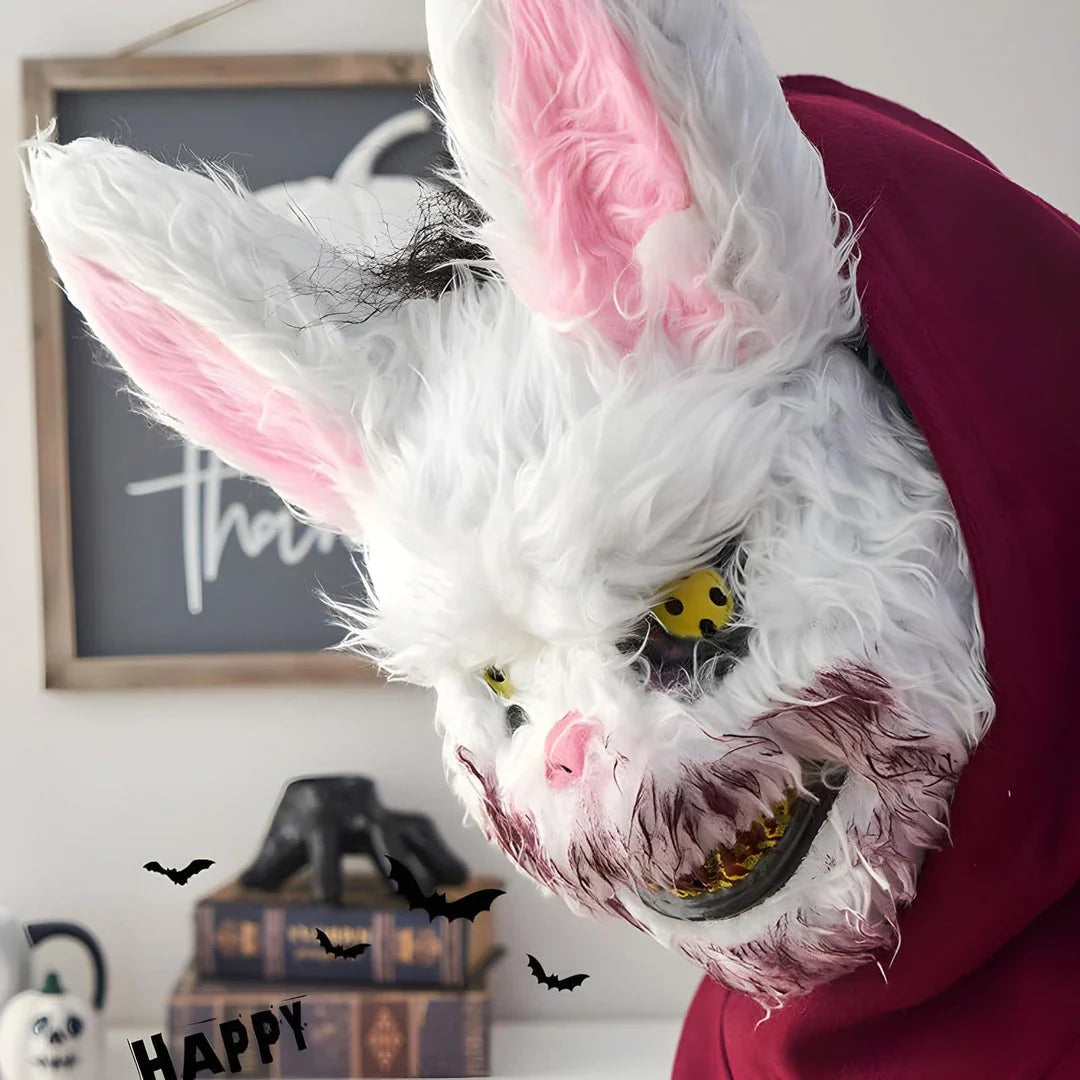 A creepy and realistic plush bunny mask with long pink ears, a bloody mouth, and glowing green eyes - perfect for Halloween and costume parties.