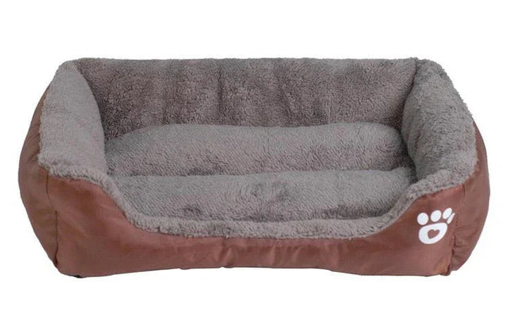 A cozy, waterproof pet bed featuring a soft fleece lining and paw print design, perfect for providing comfort and support for your beloved companion.