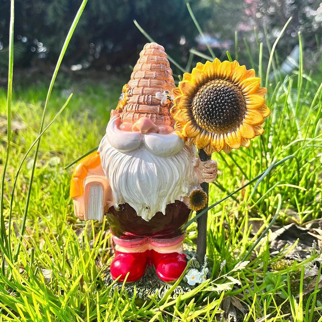 A charming resin garden gnome statue holding a sunflower and book, designed to brighten up any Kiwi outdoor space.