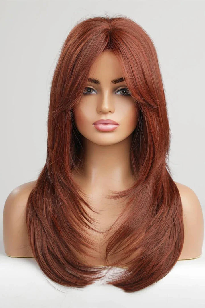 Model wearing a mid-length wave synthetic wig in a vibrant brick color