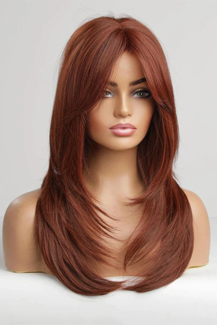 Model wearing a mid-length wave synthetic wig in a vibrant brick color
