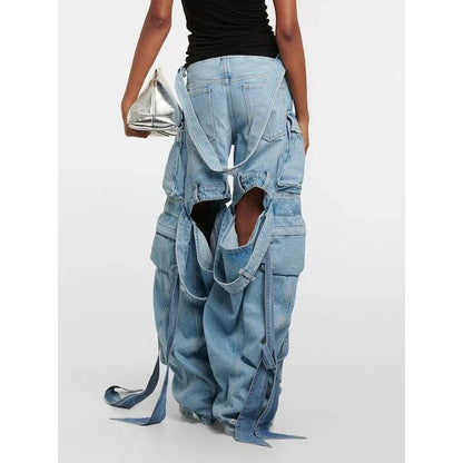 A pair of high-waisted, spliced cargo denim trousers with a distinctive patchwork and hollow-out design