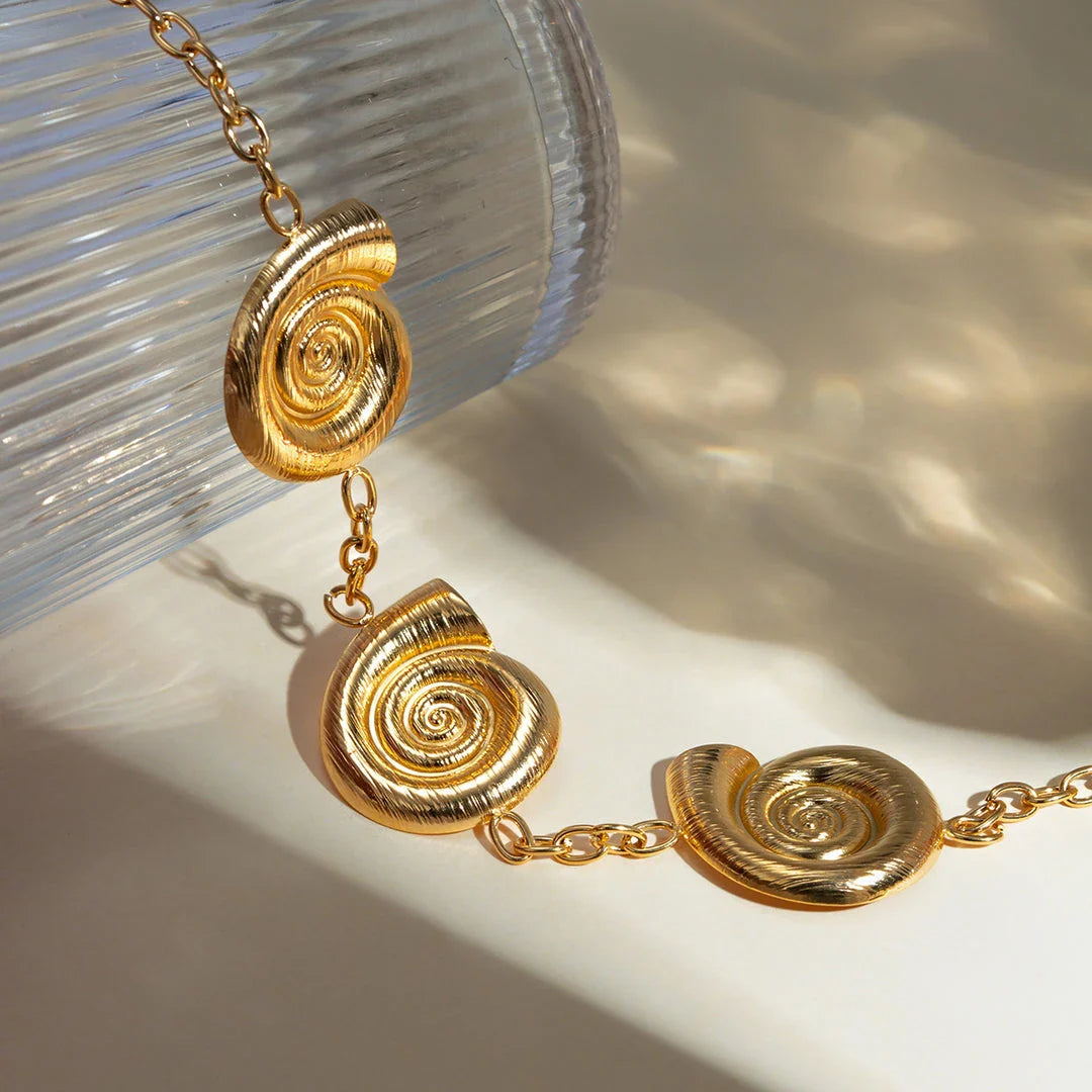 Elegant 18K gold-plated geometric spiral pendant necklace with intricate design and waterproof, hypoallergenic construction