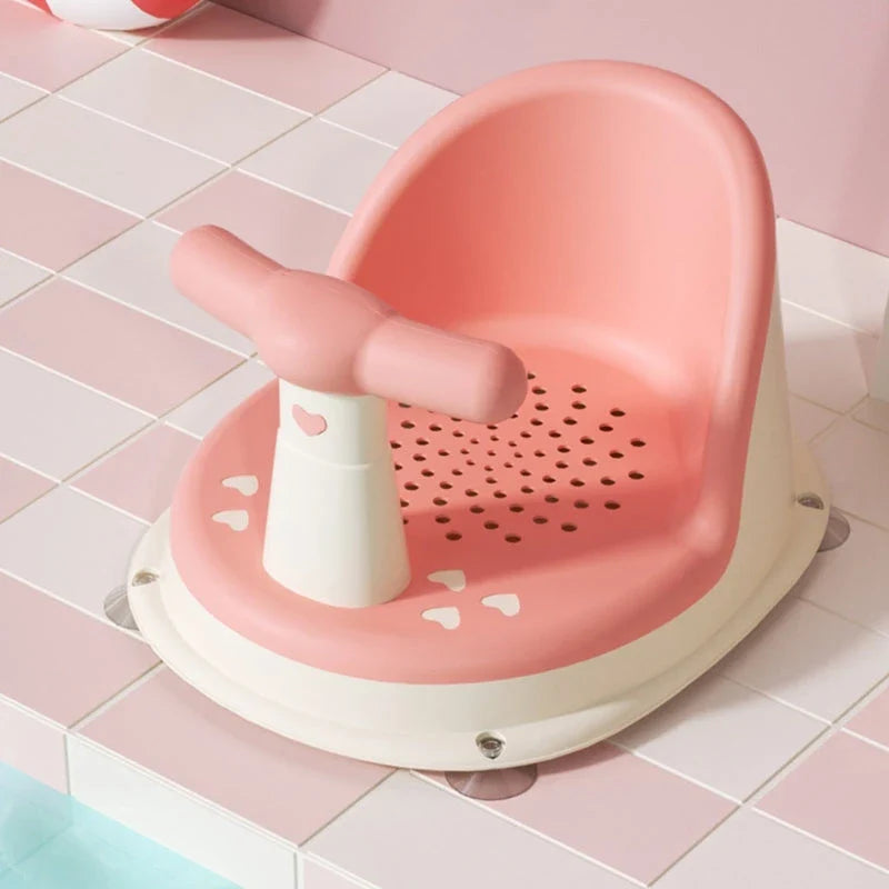 A green, ergonomically designed infant bath tub with large suction cups on the bottom to prevent slipping or tipping.