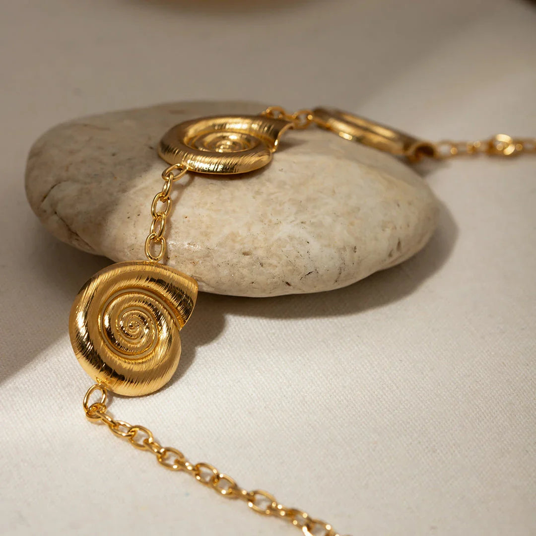 Elegant 18K gold-plated geometric spiral pendant necklace with intricate design and waterproof, hypoallergenic construction