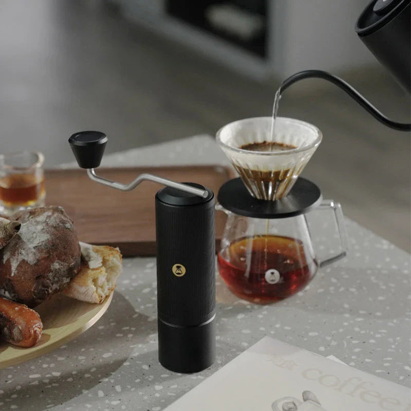 Premium manual coffee grinder with sleek design, stainless steel burrs, and external grind adjustment for customizable brewing