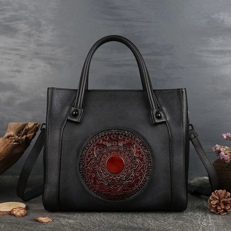 Stylish diagonal leather handbag in red, brown, and gray colours, featuring a roomy interior, multiple pockets, and a comfortable hard handle