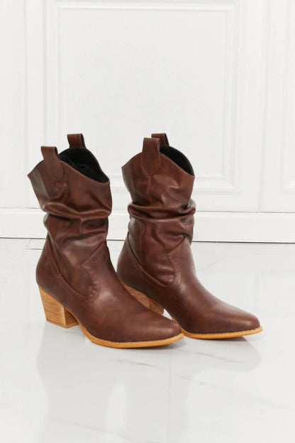 A pair of brown scrunch cowboy boots with a wooden sole, showcasing a sophisticated and stylish design perfect for Kiwi fashion.