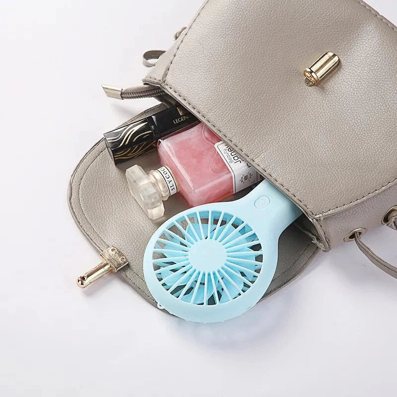 Compact USB-powered mini fan with adjustable speeds and quiet operation, ideal for home, office, and travel use