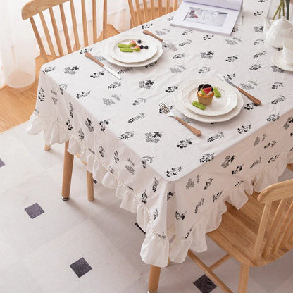 Elegant embroidered floral cotton tablecloth with ruffled edges, perfect for Kiwi homes and hospitality