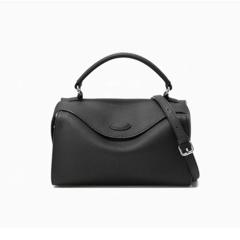 Premium cowhide leather crossbody bag with a unique pillow-shaped design, multiple interior pockets, and an adjustable strap for comfortable everyday wear.