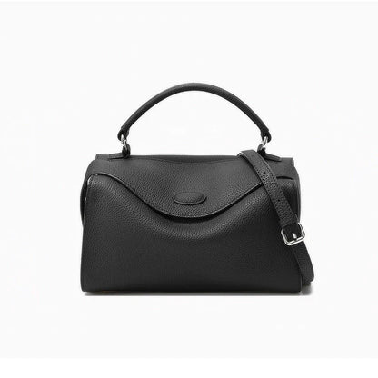 Premium cowhide leather crossbody bag with a unique pillow-shaped design, multiple interior pockets, and an adjustable strap for comfortable everyday wear.