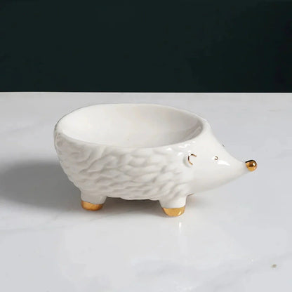 Charming hedgehog-shaped ceramic soap dish in green and white colours for bathroom decor