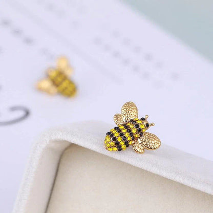 Elegant three-dimensional diamond bee stud earrings in a gold tone, featuring a sparkling design that adds a touch of whimsy and sophistication.