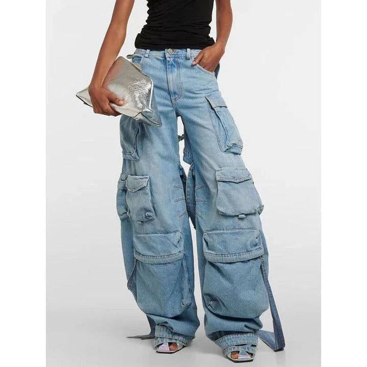 A pair of high-waisted, spliced cargo denim trousers with a distinctive patchwork and hollow-out design