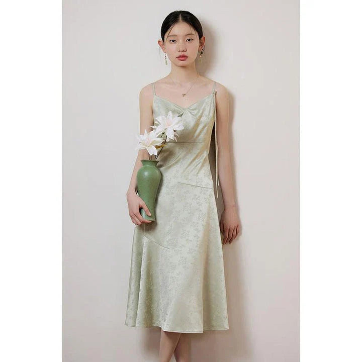 Elegant and stylish mint green midi dress with spaghetti straps, perfect for summer events and occasions.